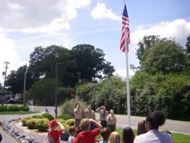Boy Scouts raise the American Flag at the dedication ceremony of the installation of a flag pole at the Parent Child Development Corporation Day Care Center in West Point, Va. The PCDC approached the Old St. John’s Chapter because they wanted a flag pole and flag on their property to instill patriotism in the children and teach them flag etiquette.