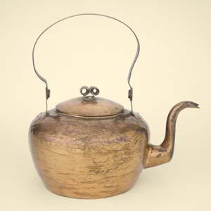 Dovetailed construction and the hammered surface of burnished copper define this graceful Philadelphia teakettle, made in about 1800.