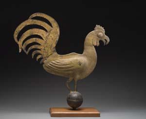 Standing upright on a copper sphere, the rooster with its three-dimensional lead body and cut sheet iron tail feathers seems almost ready to strut and crow. The wooden base was probably added in the 20th century. Donation information and research with a Watertown, Massachusetts historian reveals the weathervane was mounted atop St. John’s Methodist Church in Watertown during the mid-nineteenth century.