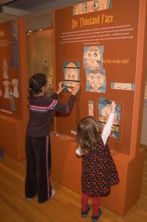 Some young Open House guests enjoy the hands-on display in the “Return to Toyland” exhibit.