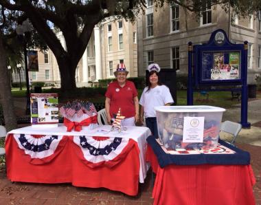 Today Bartow Chapter (Florida), DAR celebrated the Day of Service for DAR's 125th anniversary by collecting retired American flags from citizens, businesses and members.    We joined our community's Antique Fair and set up in front of our wonderful Polk County History Center pictured in the background.    Flags were taken to our local American Legion for proper disposal.