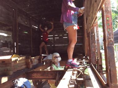 With wire brushes in hand, the Aloha Chapter ladies worked hard on the rusted metal parts inside the boxcar.