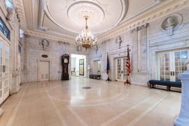 A grand lobby with polished marble floors in a spacious building.