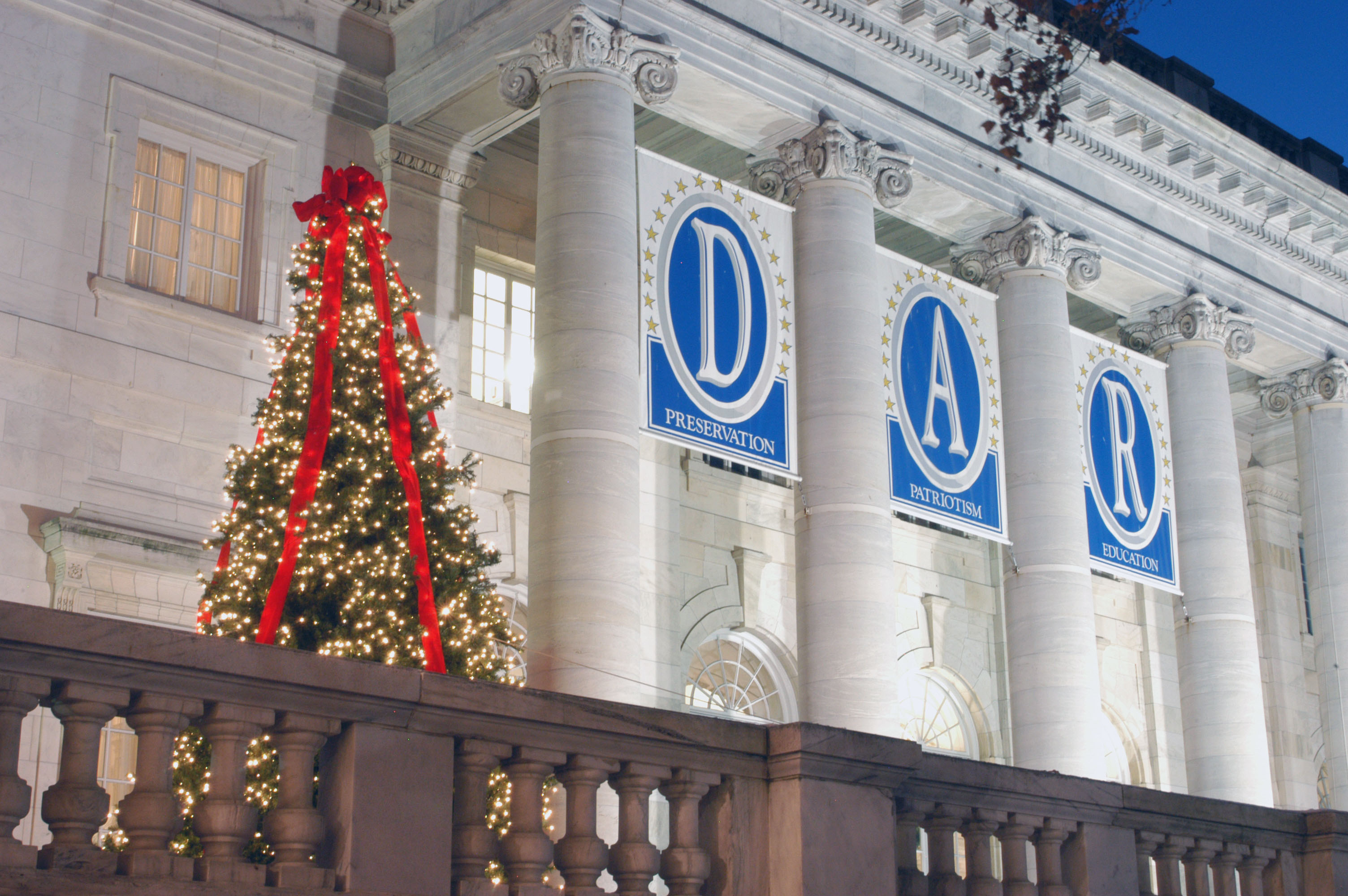DAR Building with banners and a festive Christmas tree with a red bow on top. 