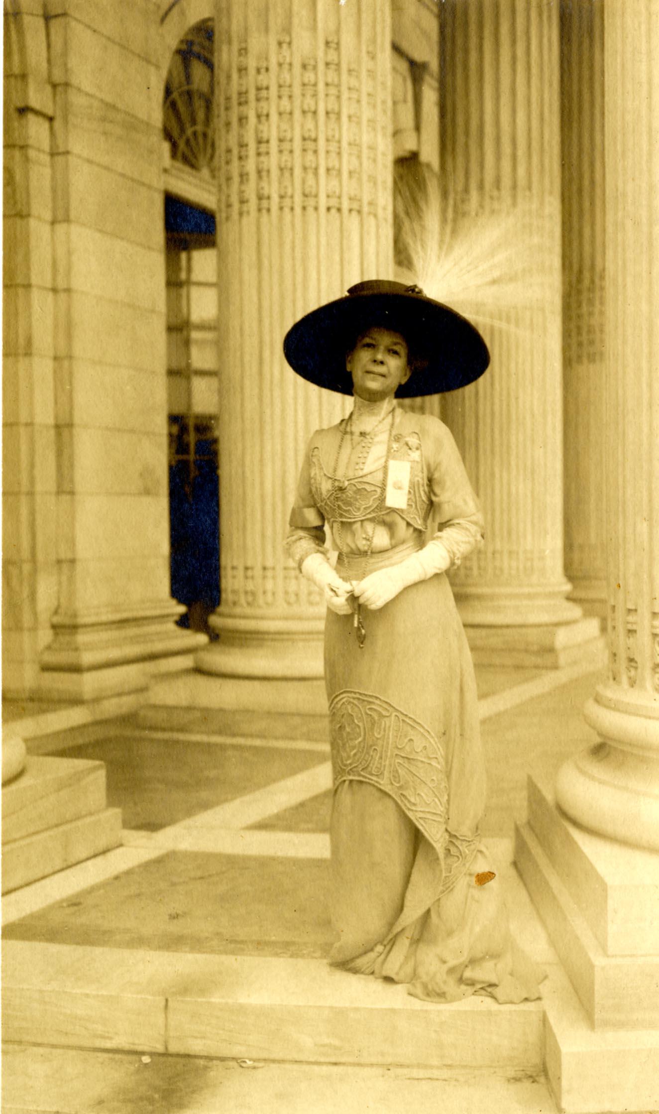 Woman standing in front of columned building