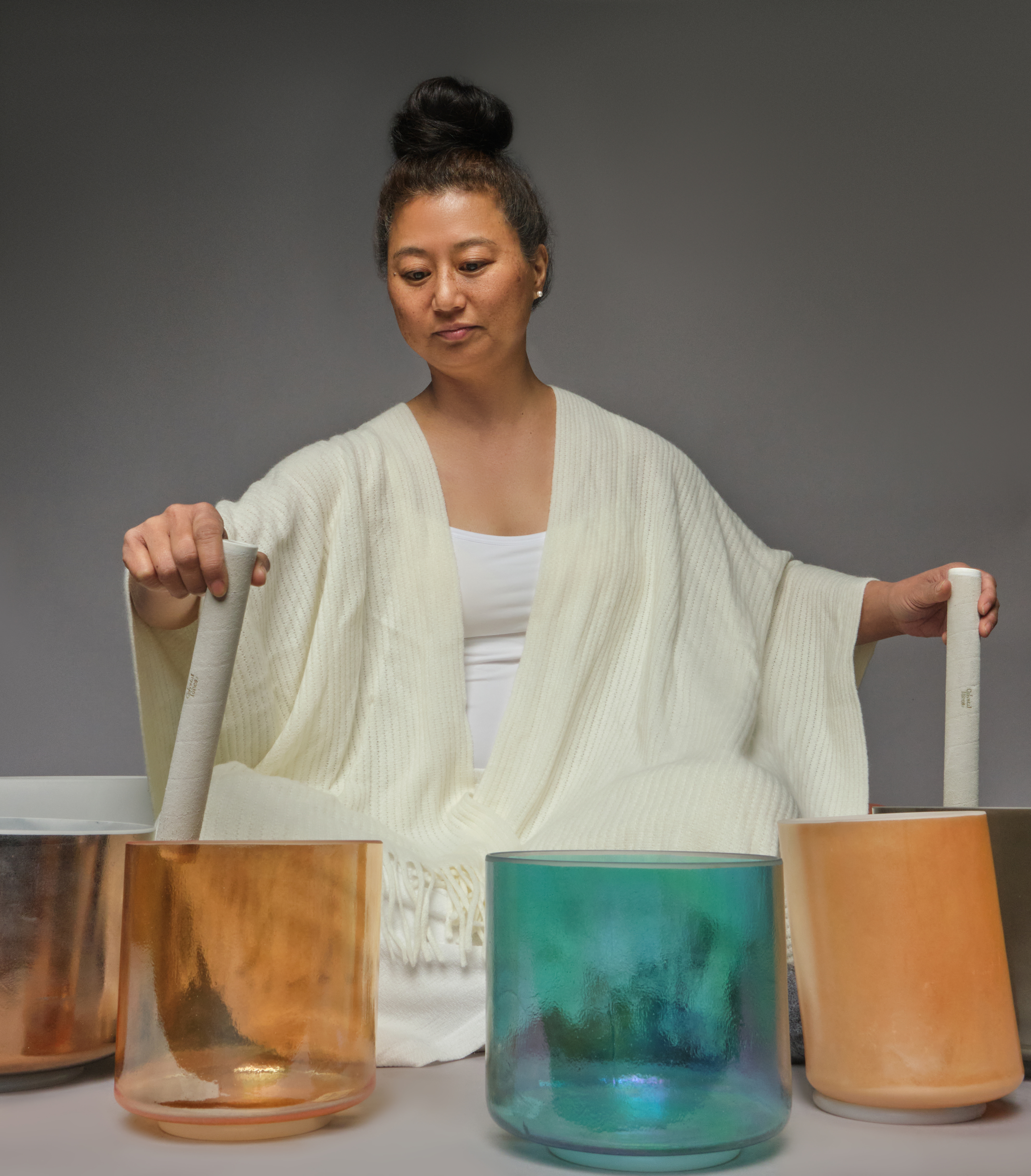 Woman performing a crystal bowl sound bath