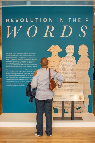 Visitor looking at Revolution in Their Words