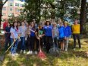Women with rakes do community service