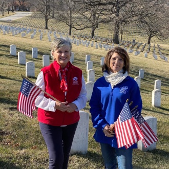 Two members at a grave cleaning service project.