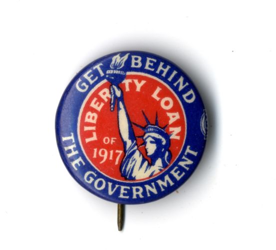 Red liberty loan pin with image of the Statue of Liberty and lettering: “Get Behind the Government” while the inside of the pin reads, “Liberty Loan of 1917.”