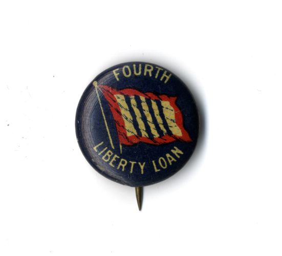 Navy blue liberty loan pin with red and white image of flag and lettering: “Fourth Liberty Loan,” circa 1918.