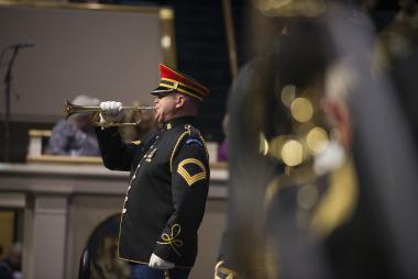 The bugler calls for the Opening Night procession to begin.