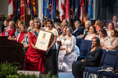 Begonia Santos accepting the President General's Medallion on behalf of QSSI