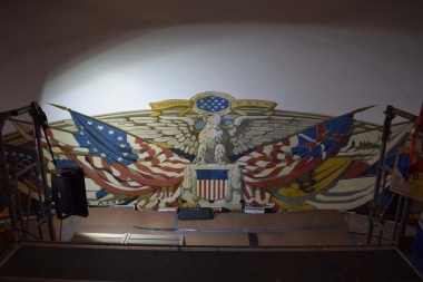 The flag mural in the dome of Constitution Hall is actually painted on canvas adhered directly to the plaster of the dome and cornice with adhesive and small tacks.