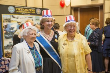 President General Lynn Young has a playful moment posing with Brigadier General Wilma Vaught of WIMSA and a DAR member.
