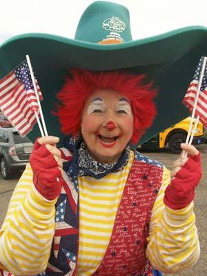 Marsha Berland, a member of the Cactus Wren Chapter, Arizona, is a professional clown and often volunteers her time. Her alter ego, "Marshmellow," is a very patriotic clown dressed in red, white and blue and carries U.S. Flags when she is in parades. As she is also the literacy chair for her chapter, she tries to incorporate an element of reading in her message to children. This photo was taken when she was "clowning" at the Phoenix School for Homeless Children.