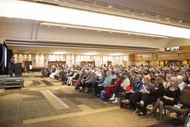 The jam packed crowd at Celebrate America Night listens attentively to Terry Richey, Chief Marketing Officer at the National Trust for Historic Preservation, as he speaks about preservation opportunities members can become involved in in their local communities.