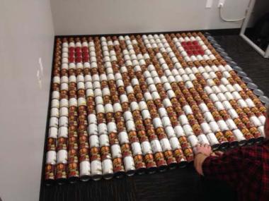 Motivating co-workers to make a difference can be an experience. But for Allie Golon of the Doctor Susan Anderson Chapter in Colorado, she is up to the challenge! In order to boost the supplies at the local food bank before the holidays, she coordinated a canned food design competition for teams of her fellow employees. Each team was tasked with creating a structure or design of high protein/high caloric food items that were all then donated to the local food bank. They collected 1.5 tons of canned food (ov