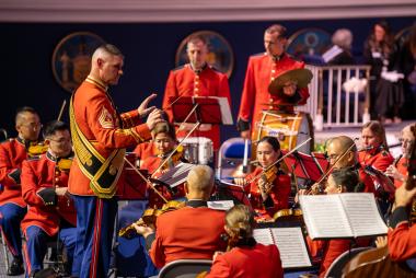 A marine conducting an orchestra