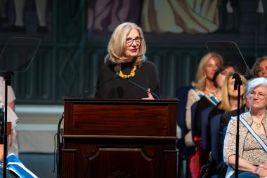 Woman speaks at podium 
