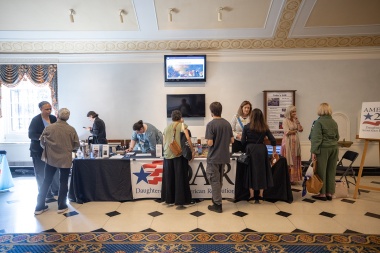 Attendees visit the DAR Information table 