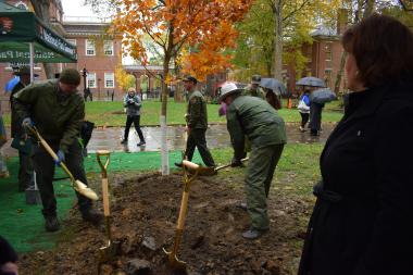 National Park Service rangers assist with the final grunt work of planting the DAR tree.