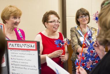 American History Committee members at Celebrate America night share information about the work their committee members have done throughout the year and how others can get involved.