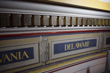 The paint work around the state names that was chipping and fading prior to being painted white during the restoration to take back to the original neutral color scheme of the Hall.