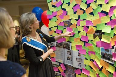 President General Lynn Young reads some of the many volunteer stories posted by Daughters from around the world on the Celebrate America! Wall.