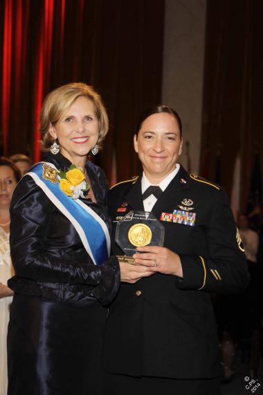 President General Lynn Young presents the Margaret Cochran Corbin Award to Staff Sergeant Julia A. Stalker, a flight medic who received the Distinguished Flying Cross for the extraordinary courage she displayed during the course of a 60-hour rescue mission in the jungle of Afghanistan in late June 2011.