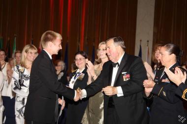 General Mick Kicklighter, who addressed the audience on the efforts of the Vietnam War Commemoration, congratulates the National Outstanding Youth Volunteer winner, Mitchel Wirth, for his commitment to veterans.