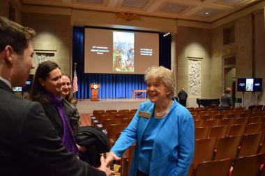 DAR President General Ann Dillon meeting Desmond Herzfelder, a student advocate for honoring the mural, along with members of the mural artist’s family