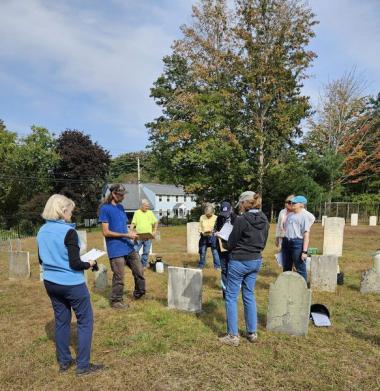 Members clean up a cemetery. 