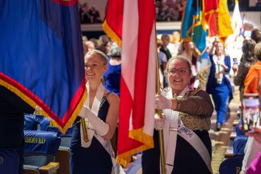 Women holding flags processing 