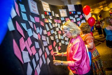 Members share their service stories on the Celebrate America! Wall.