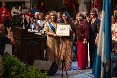 A girl posing with certificate award and execs