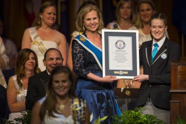The GUINNESS WORLD RECORD Adjudicator presents the official Record Holder certificate to President General Young.
