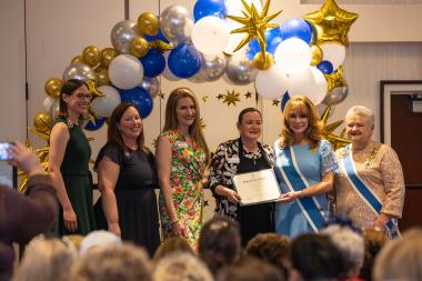 Woman accepts award