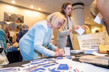 Woman participates in service project by making veterans cards.
