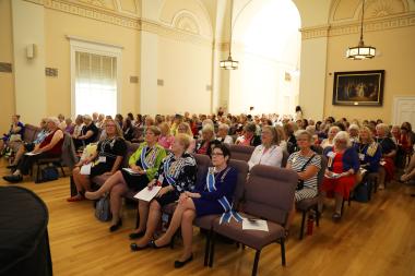 Women sit listening to a presentation
