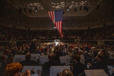 Auditorium procession with American flag waving above