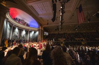 Patriotic auditorium filled with people and patriotic backlighting