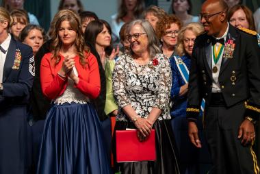 DAR member smiles on stage with other award winners.