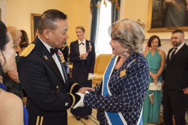 President General Ann Dillon greets Americanism Award winner Brigadier General Lapthe Flora