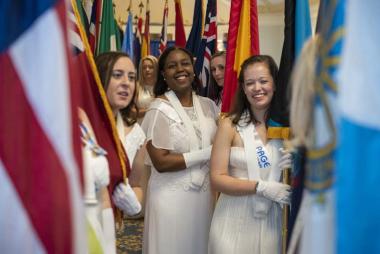 Pages prepare for the processional of the state flags
