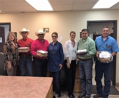 Atascosa Chapter, TX present local police and fire departments with trays of cookies, cases of bottled water and Gatorade, in appreciation for their service. 