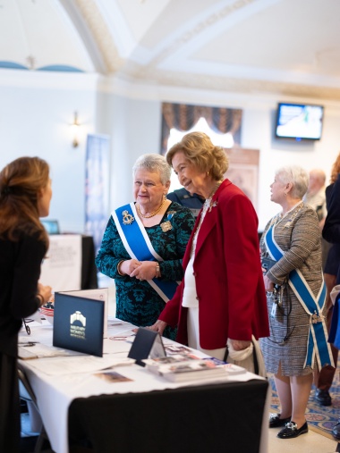 Two women interact over a table at the Symposium. 