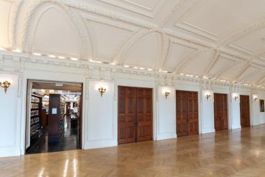 Large brown doors open to the library