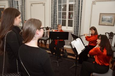 A flute ensemble group plays holiday music in the Connecticut Board Room.