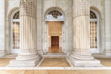 Front entrance to a grand building with columns.
